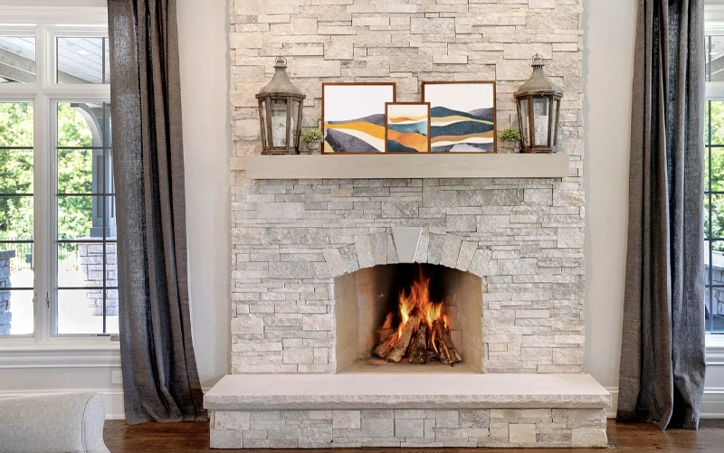 Stone fireplace showing the hearth, mantel and surround components