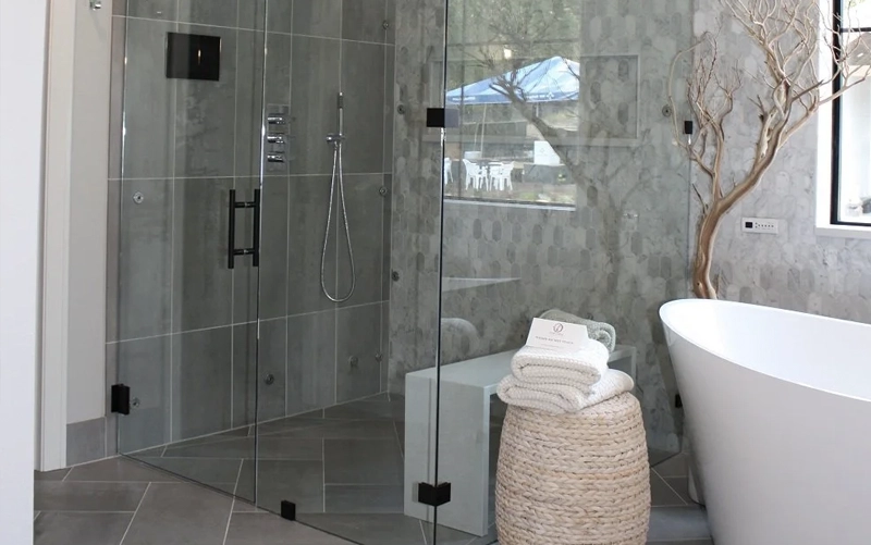 Custom stone shower threshold and curb with frameless glass in Toronto