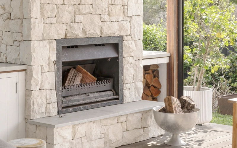 Comparison of a framed stone fireplace surround and a full-height slab fireplace wall