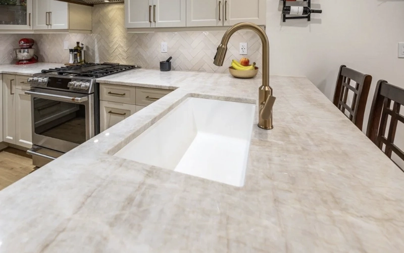 Quartz countertop and island planned as part of one coordinated kitchen project