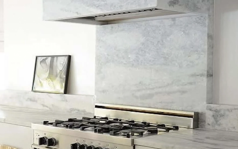 Cooktop and slab backsplash planned with appliance clearances and wall-panel openings