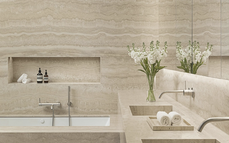 Stone shower niche sill showing drainage detail and flexible perimeter joints