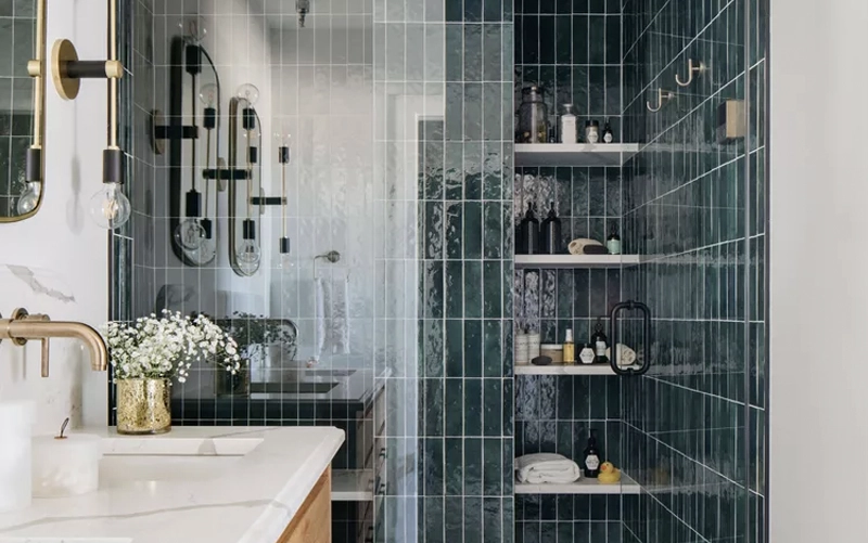 Stone-lined shower niche compared with a fully tiled shower niche