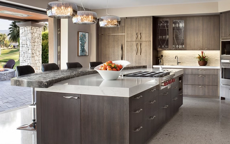 Warm white grey and dark stone countertop samples beside oak walnut and maple cabinet finishes