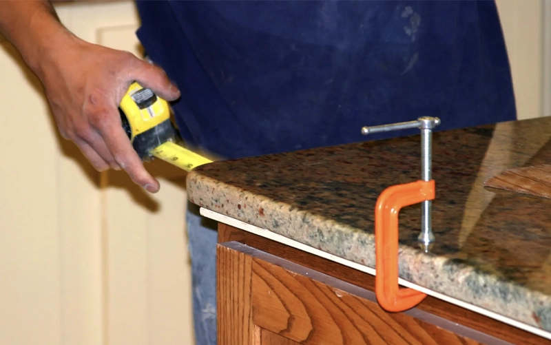 Fabricated stone countertop being delivered and positioned during professional installation