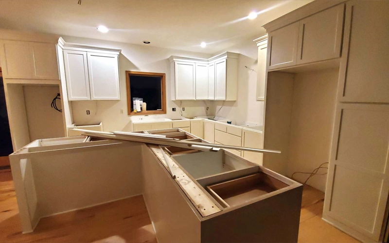 Questions to Ask Before Hiring a Countertop Installer Homeowner reviewing countertop installation details with a professional installer